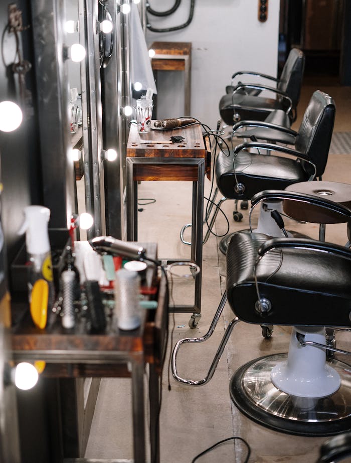 Black Leather Barber Chair in Front of Mirror
